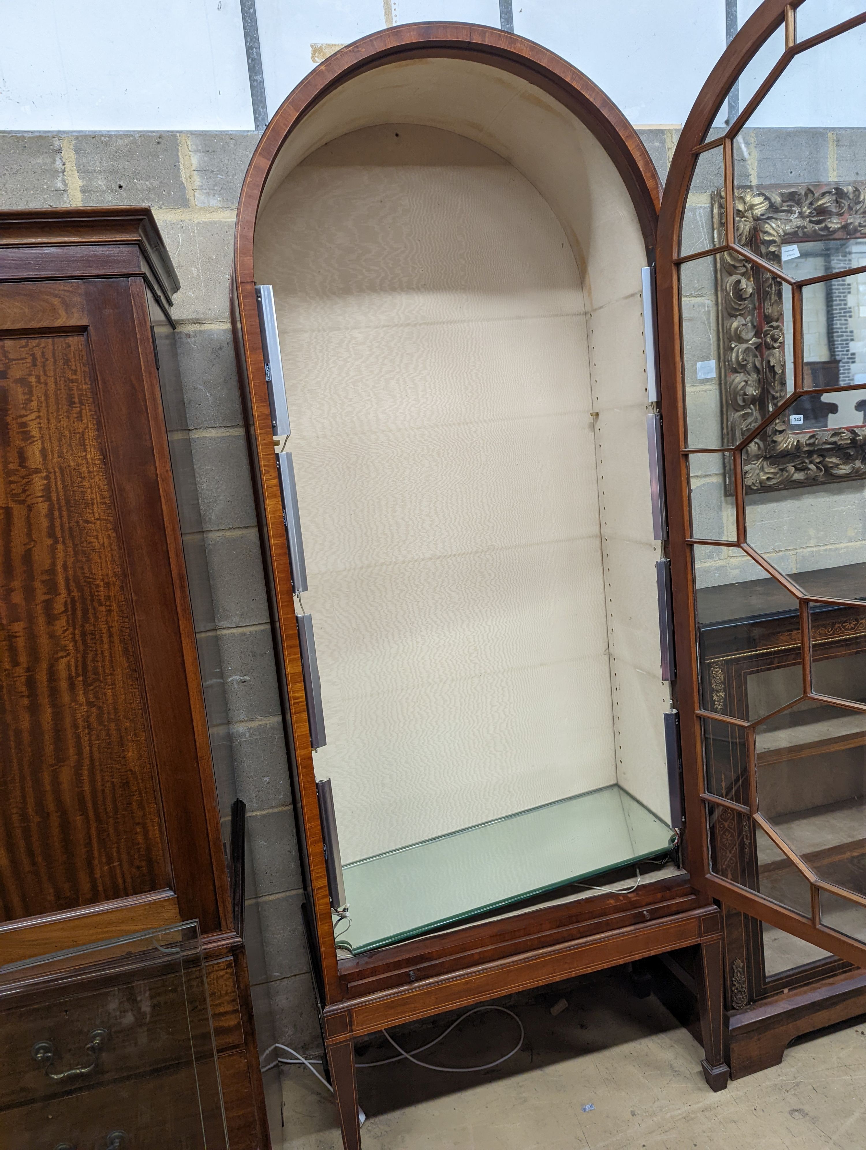 A George III style mahogany and tulipwood banded, domed topped china display cabinet, raised on a stand, width 87cm, depth 39cm, height 225cm